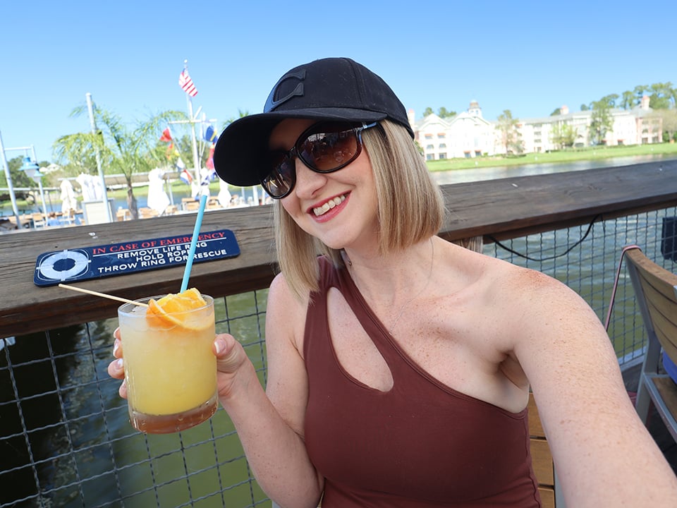 woman holds drink at disney springs