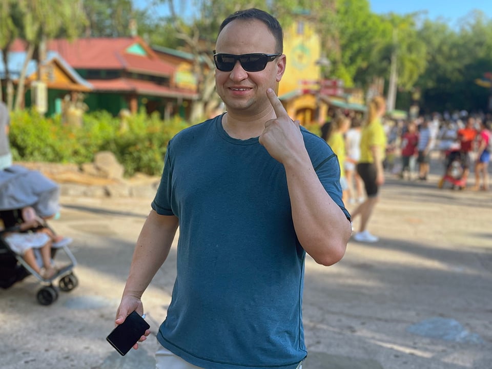 a man points at his face in animal kingdom