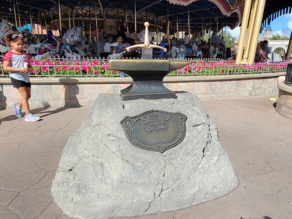 The Sword in the Stone with the Prince Charming Regal Carousel in the Background
