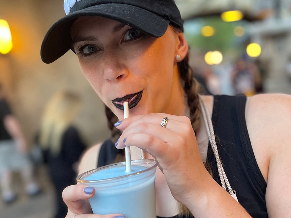 A Guest Sips on Blue Milk from Milk Stand