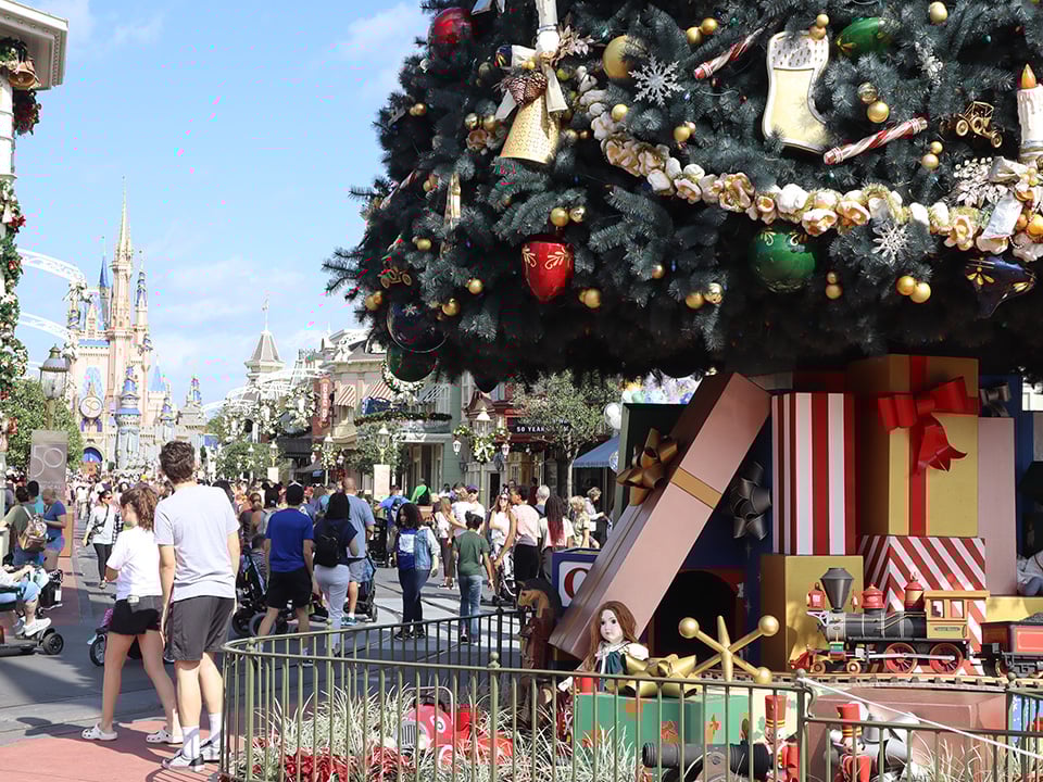 Guests Wear Shorts Near Christmas Tree Walk Disney's Magic Kingdom
