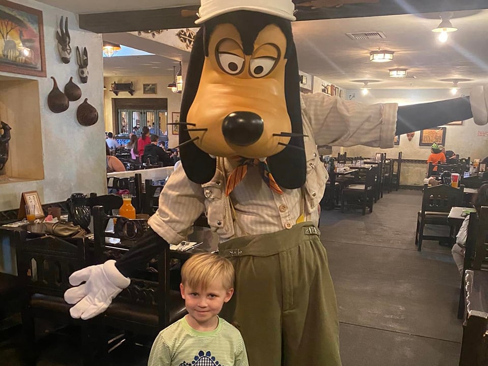 Child Poses With Goofy at Tusker House