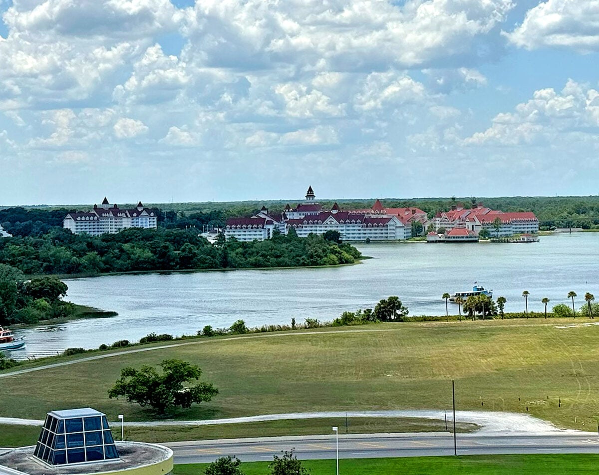The classic red and white buildings of The Grand Floridian Resort & Spa as seen from across Bay Lake at the Contemporary. (©John Gullion/Hey Orlando).