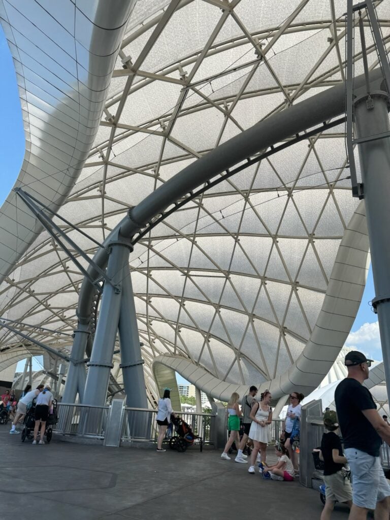 The Tron: Lightcycle Run Track runs under the canopy and above the crowd. (© John Gullion/Hey Orlando).