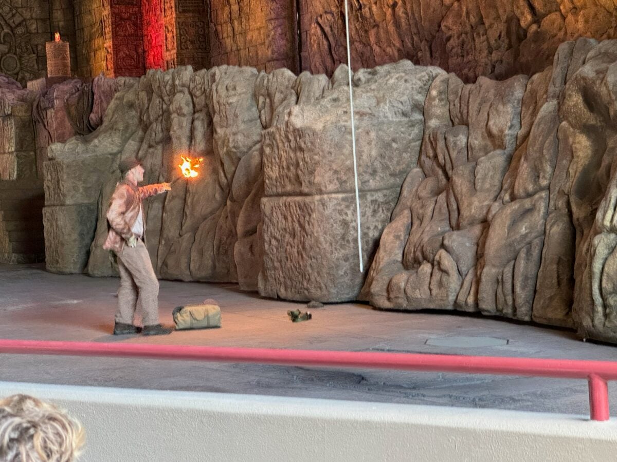 An actor/stuntman, playing a stuntman for the actor playing Indiana Jones (Harrison Ford?) recreates a version of the opening minutes of Raiders of the Lost Ark as part of the Indiana Jones Epic Stunt Spectacular at Hollywood Studios. (©John Gullion/©Hey Orlando).