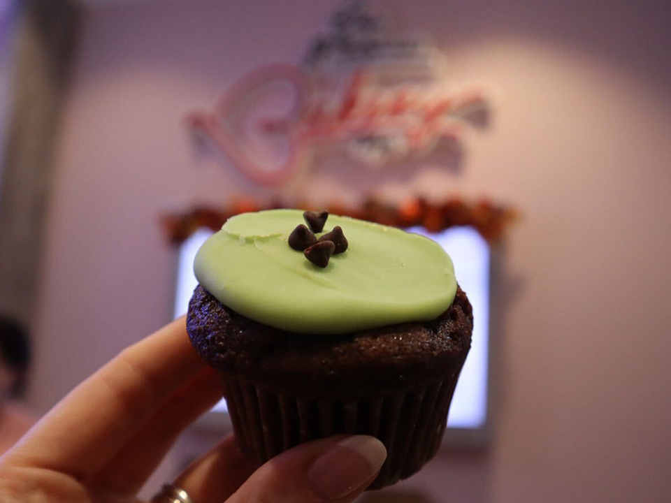 chocolate muffin with green icing at erin McKenna's bakery in disney springs