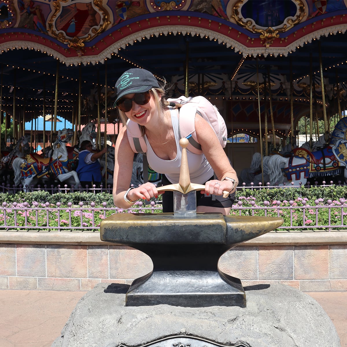 a woman tries to pull the sword in the stone at disney
