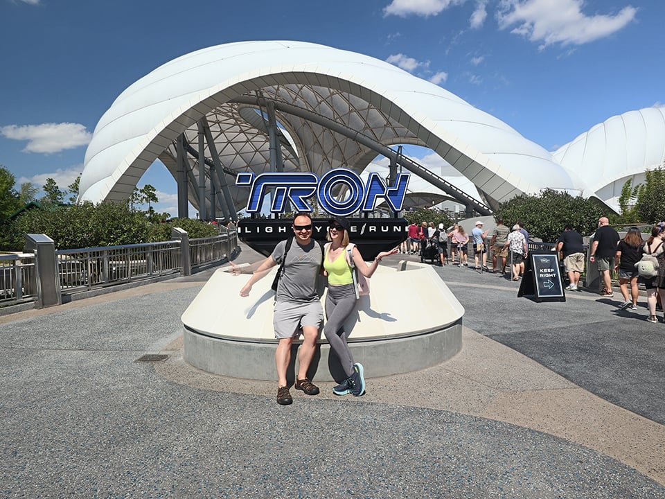 a couple in front of the tron ride