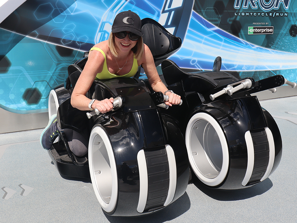 A Young Woman Tries Out the Tron Lightcycle Car