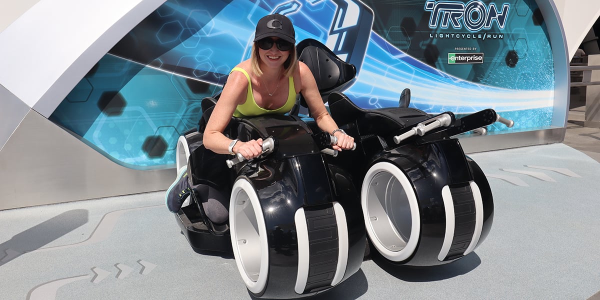 a woman uses a tester seat at TRON lightcycle run