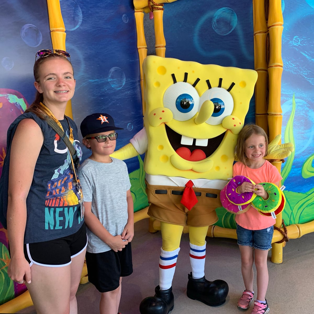 spongebob character poses with three children